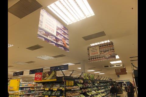 Cheap Stella Artois and Cadbury's chocolate is advertised above the vegetables